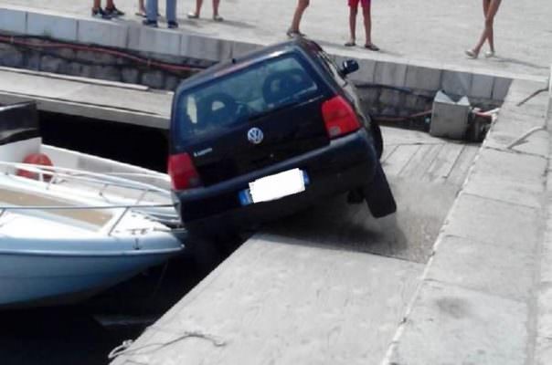 Auto in folle finisce al porto: mezzo sospeso tra la banchina e un’imbarcazione