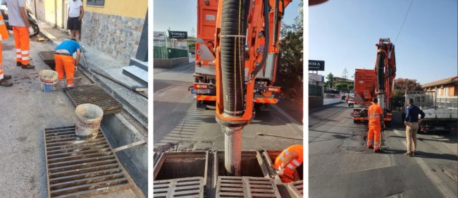 Operai in azione con il canal jet e lavoro manuale per pulire i tombini di Catania